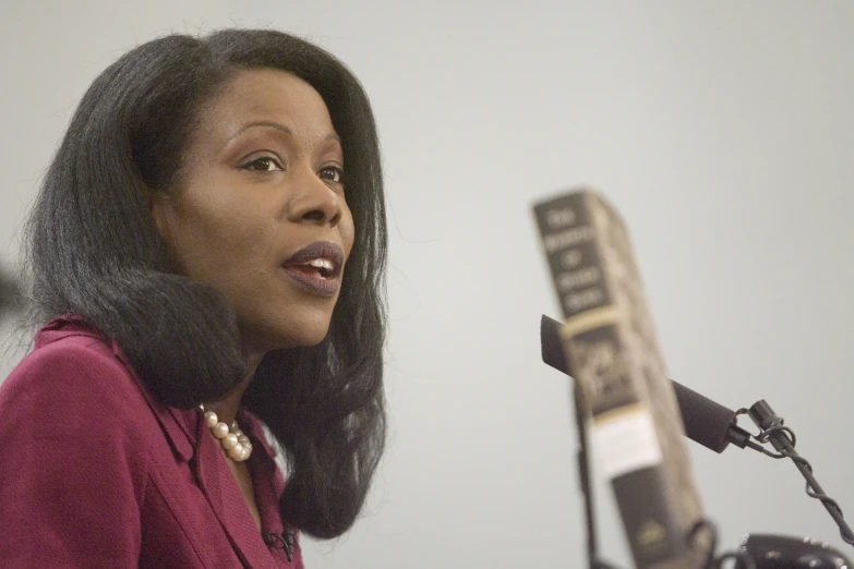 a woman is speaking into the microphone