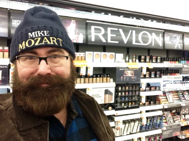 a man standing in a store next to his shelves