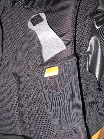 an electronic device in a pocket on a backpack