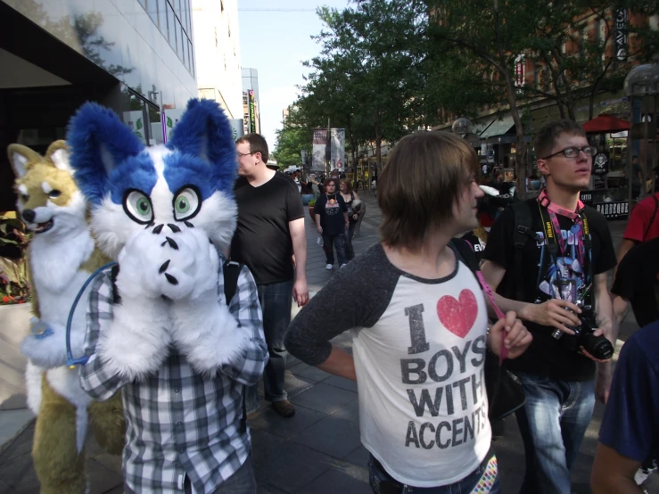 man and girl dressed in costume walk in street