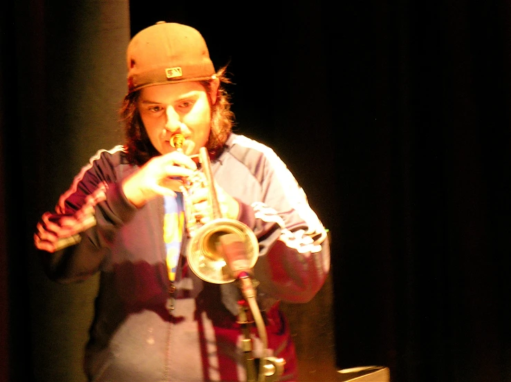 a man playing a trumpet on a stage