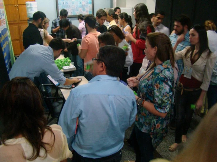 there are many people standing in line to be served cake