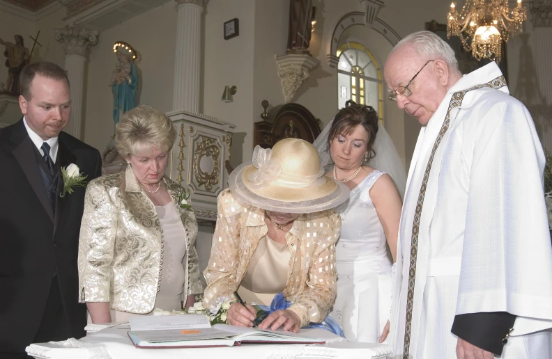 a couple of people standing by a wedding cake