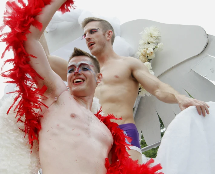 two guys that are dressed up and are posing for the camera