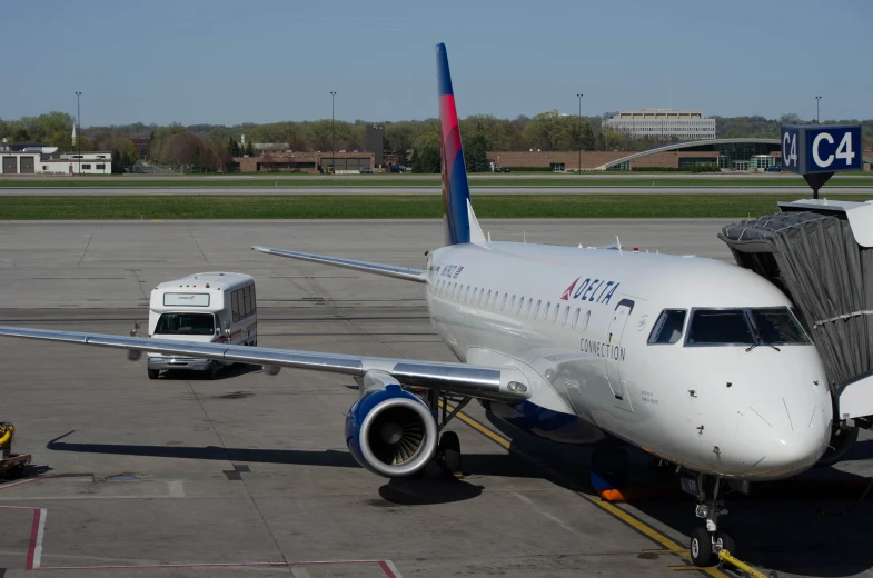 a white delta airplane parked on the runway