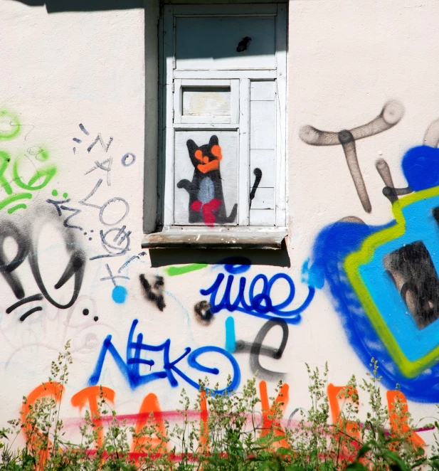 some graffiti on a building with a window