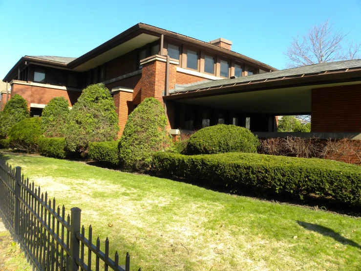 there are three buildings behind the grass in front of the building