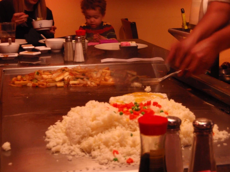 a table is filled with rice, beans, and veggies