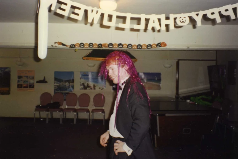 a woman with pink hair is wearing a costume