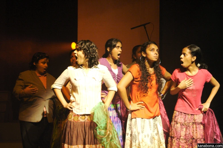 four young women standing next to each other