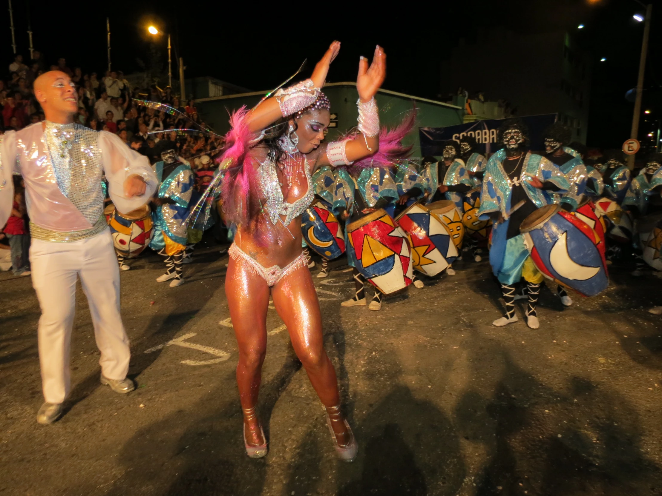 two young dancers perform in front of a large group of people