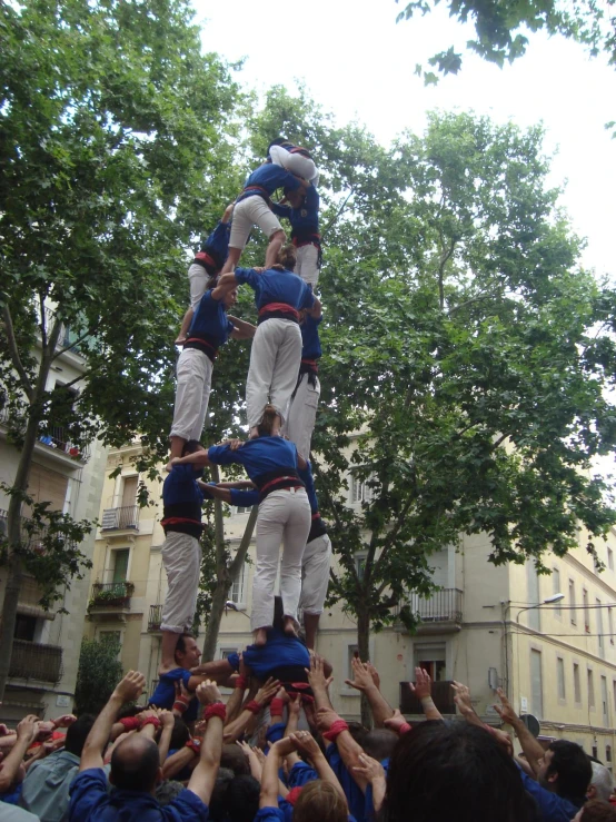 many people and some one is standing on a small tower