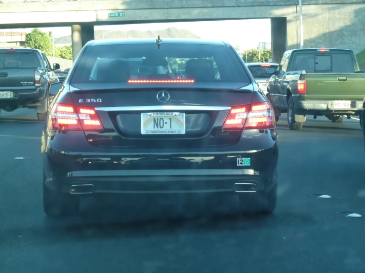 a car stopped on a road next to several other cars