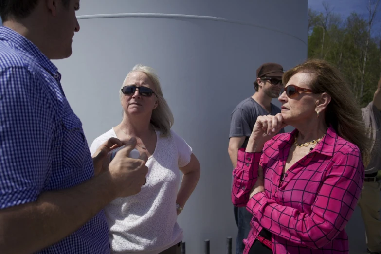 a group of people standing around a tank