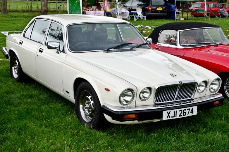 two very nice looking cars parked by each other