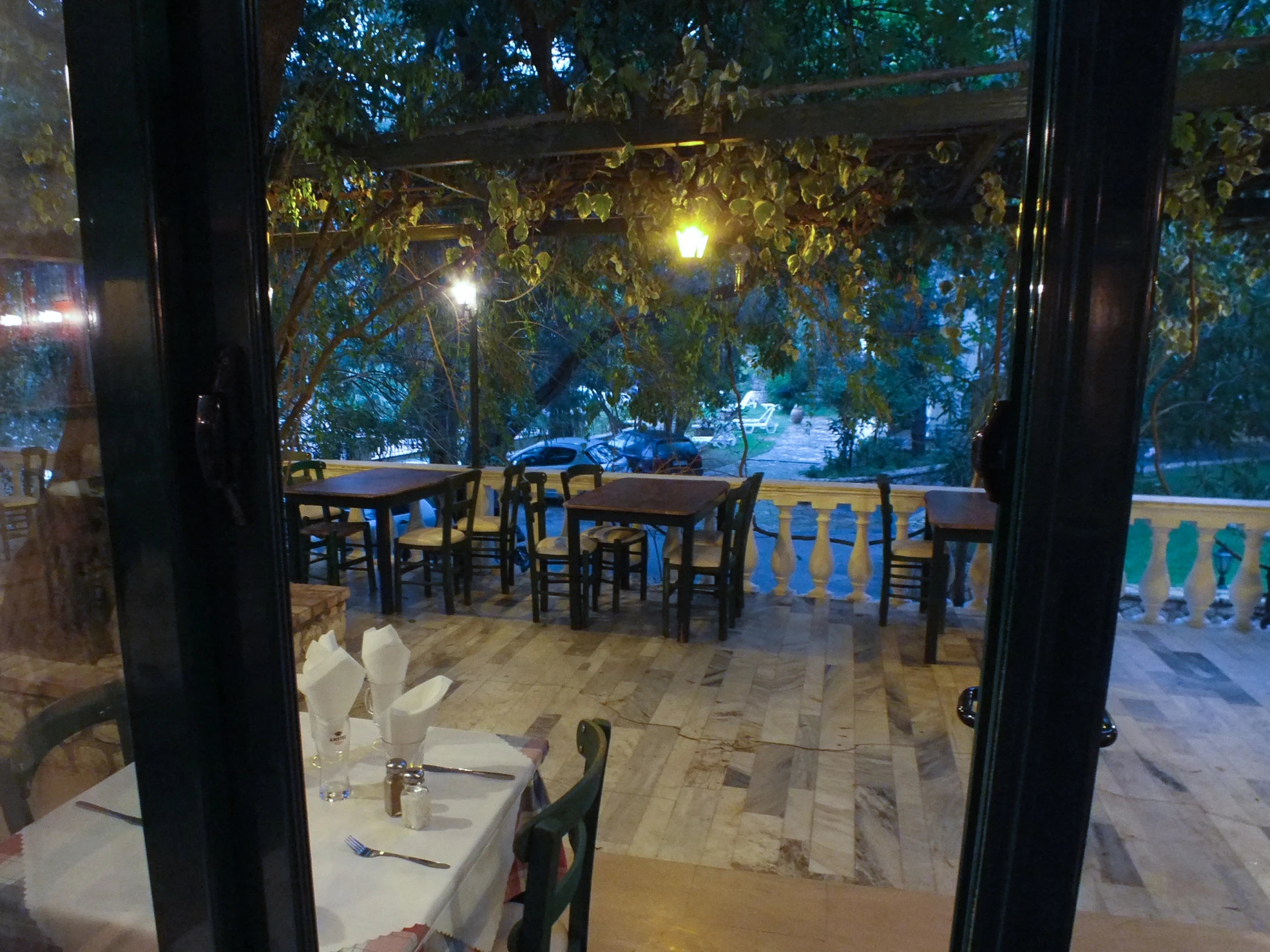 a table on the deck of a restaurant with no one around it