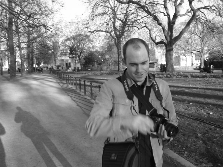 a man taking a pograph on a bench