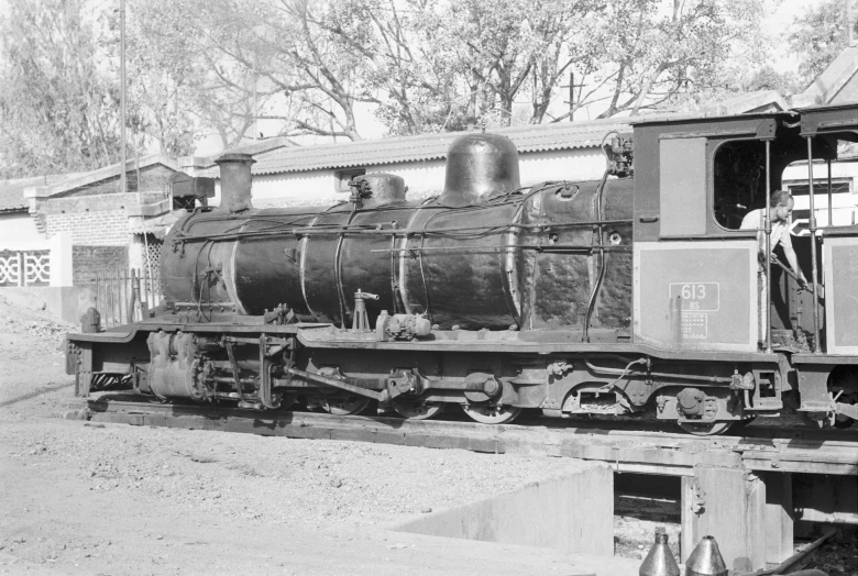 a vintage locomotive sits in an old fashioned train yard