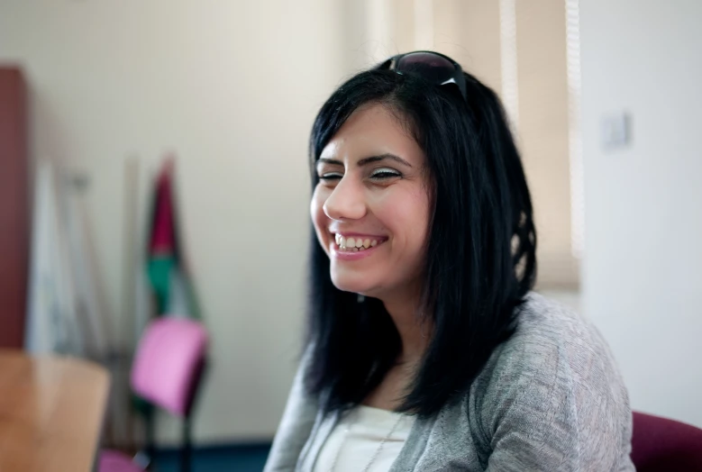 woman in glasses smiling for the camera