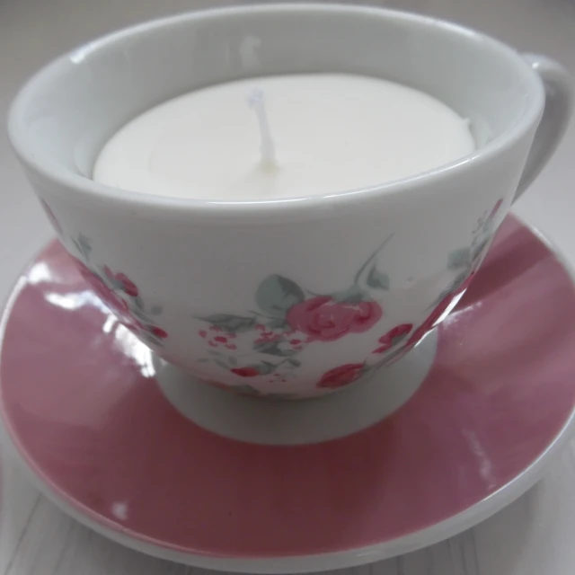 a teacup that has a candle inside it