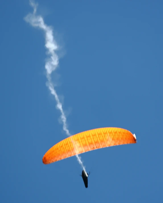 the kite is making a smoke trail