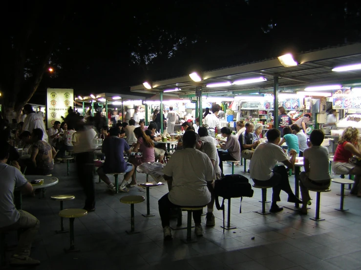 a lot of people that are sitting at some tables