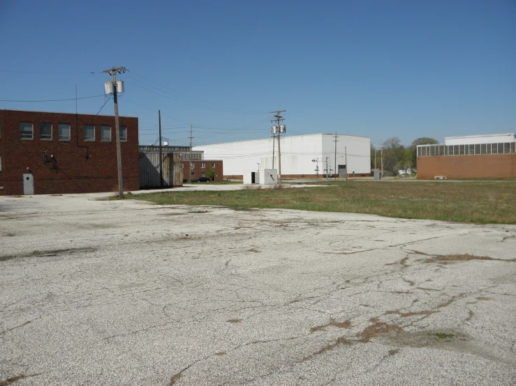 an empty parking lot in front of some brick buildings