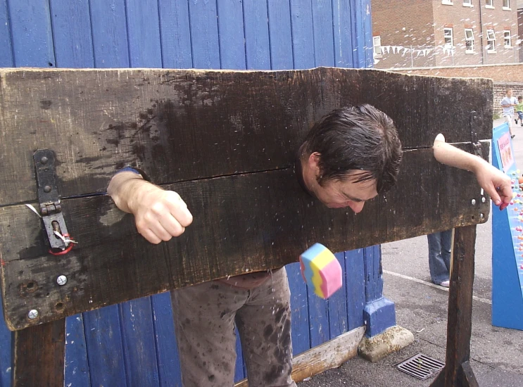 a man is holding onto a large piece of wood