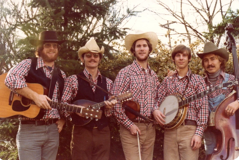 a group of people playing instruments near trees