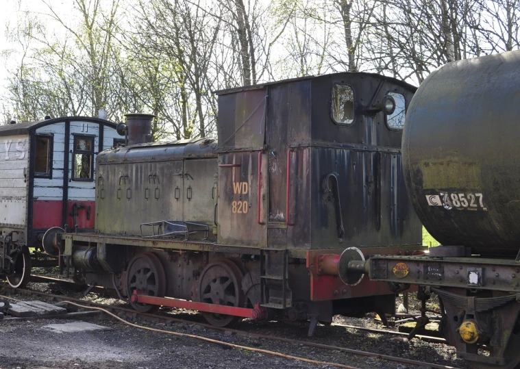 an old train car sits on railroad tracks