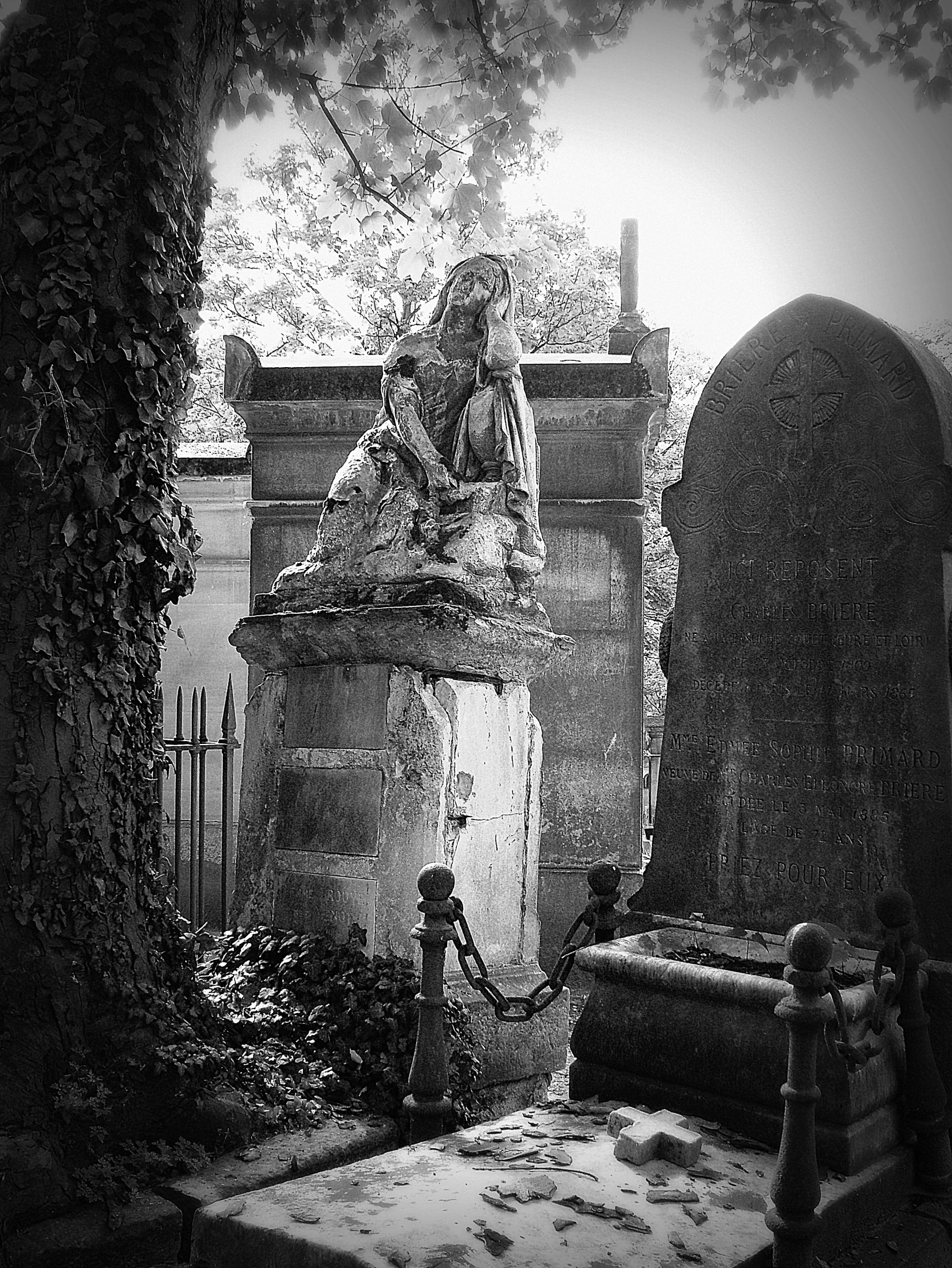 a woman in white is walking towards a grave