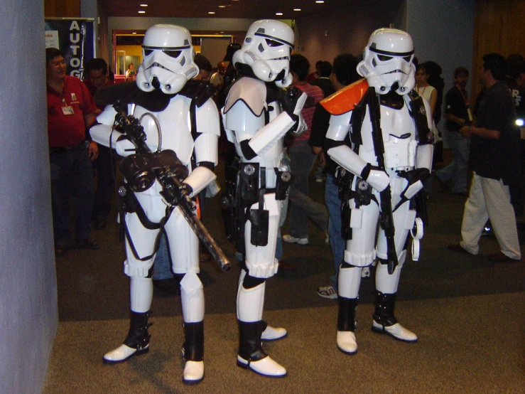 three costumes standing in a row in front of people