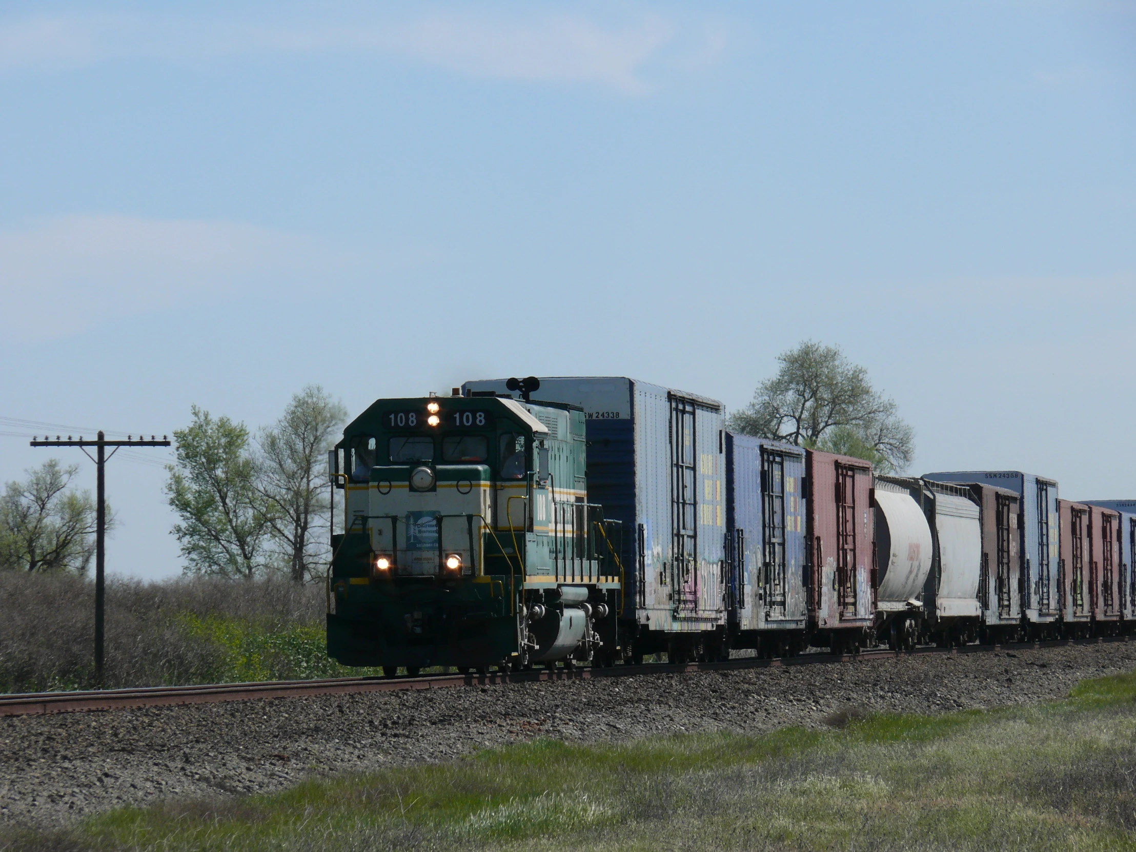 a train driving along the railroad tracks on it's way to another track