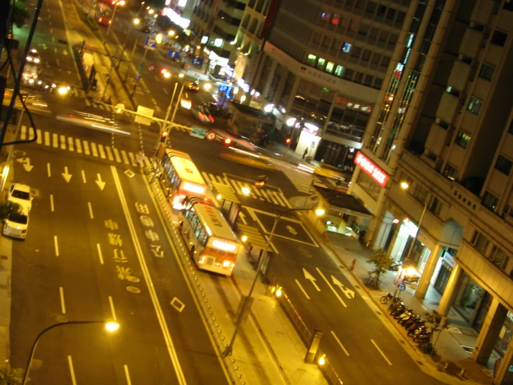 a city street at night time in the middle of an intersection