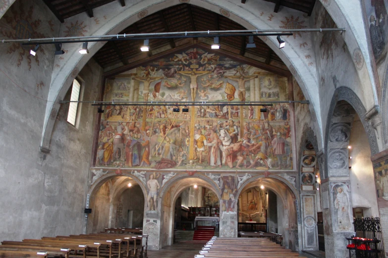 church scene with colorful painted wall and pews