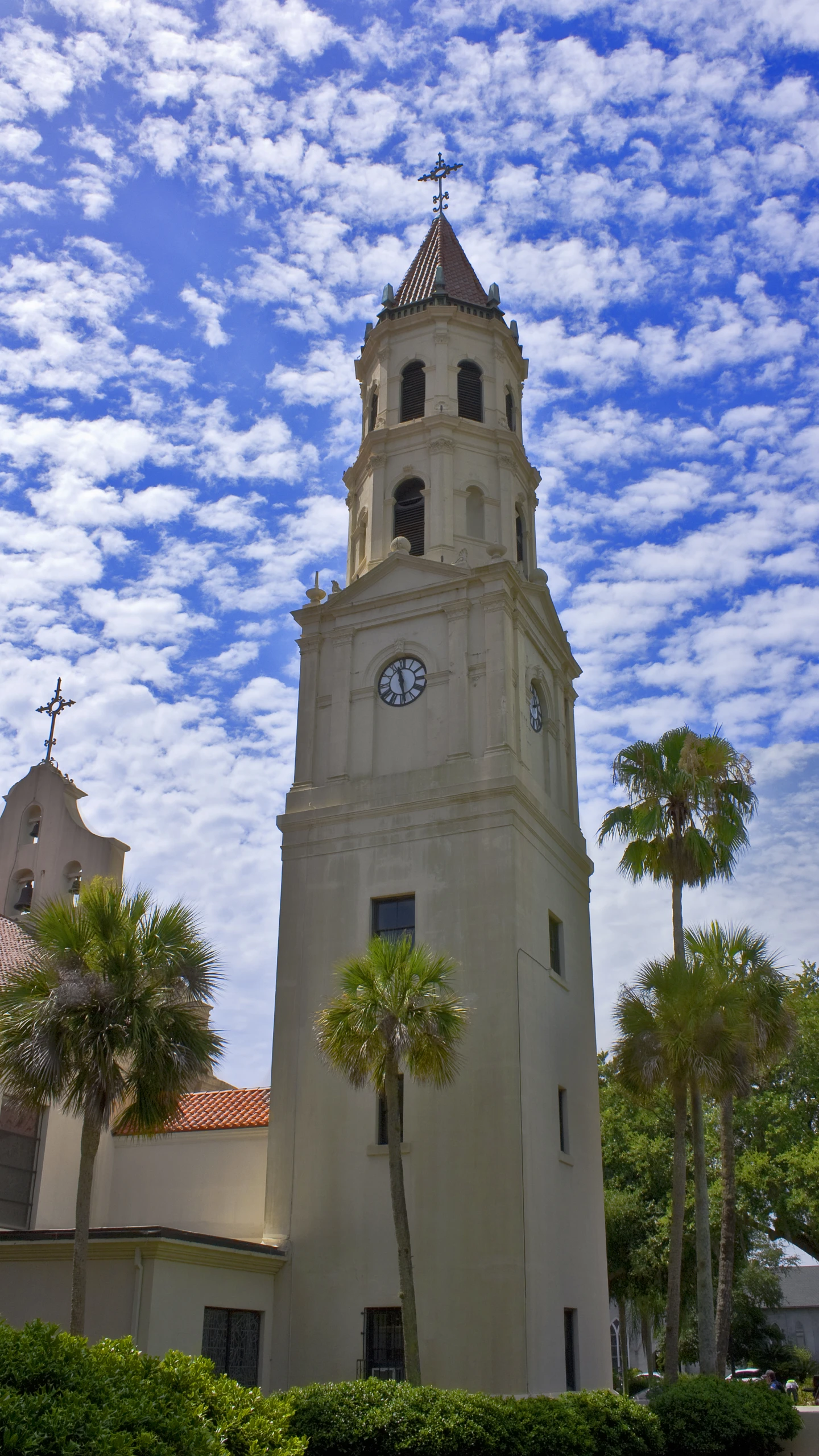 this is a church steeple in the day with a blue sky and clouds