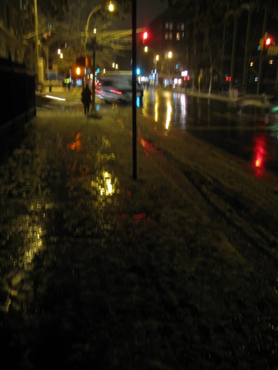 a person crossing the street on a rainy night