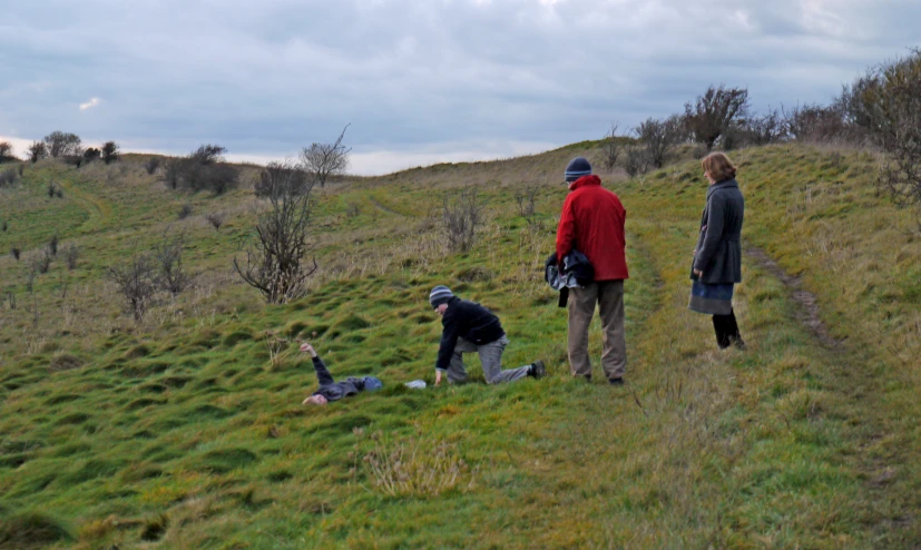 a group of people standing on a lush green hillside