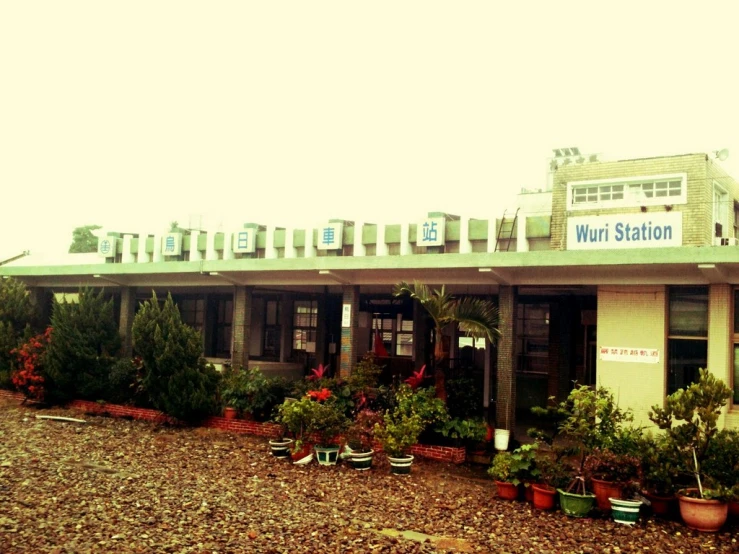 a building with lots of pots of flowers in front of it