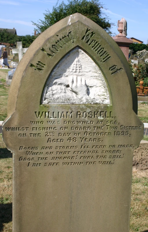 a headstone that is on top of a cement grave