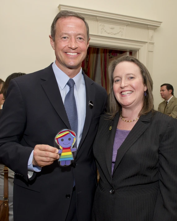 a man and woman smile for the camera