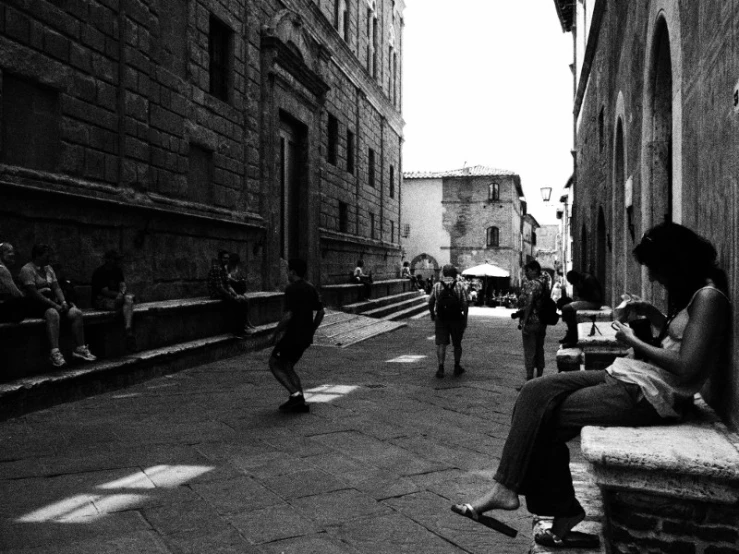 children playing on a city street in a black and white po