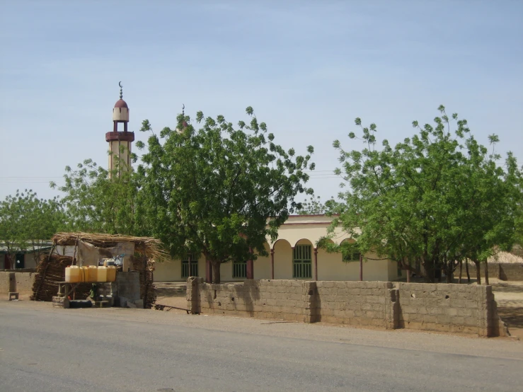 there is a very large clock tower near the trees