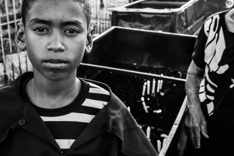 a black and white po of two boys in front of a water fountain