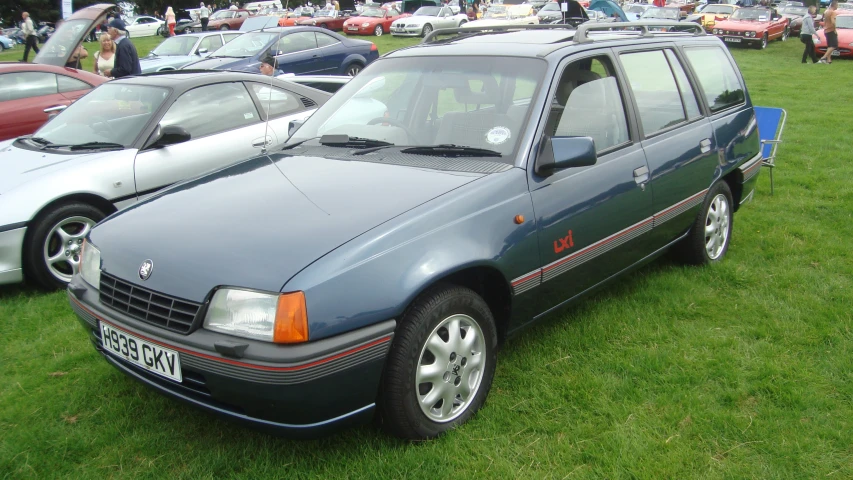 cars sitting on top of a grass covered field