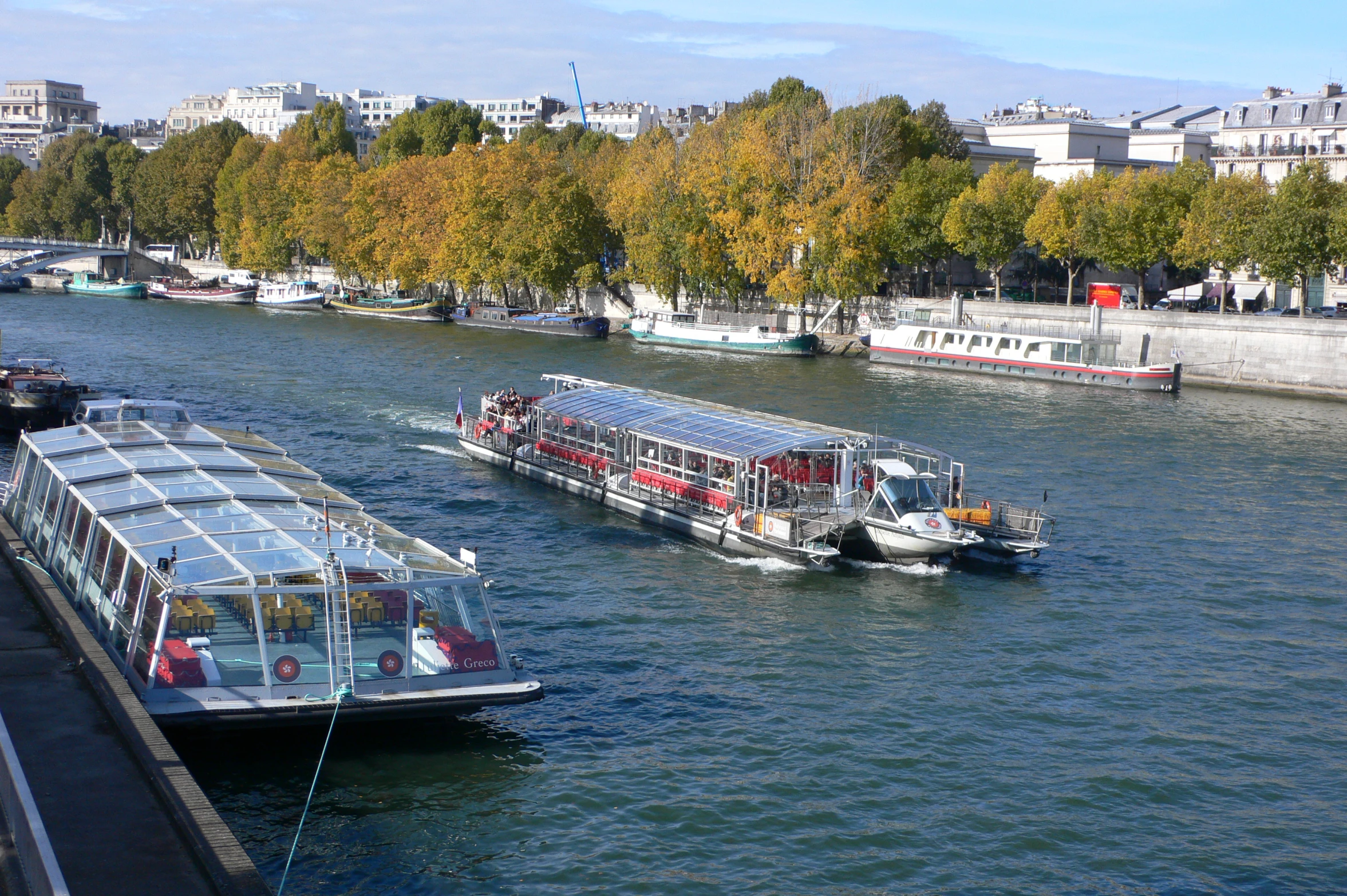 a river has boats traveling down it and some trees