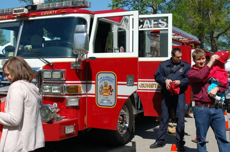 many people are gathered outside near an fire truck