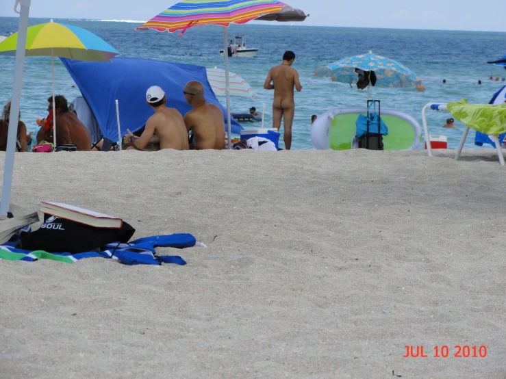 several people at the beach in the sand