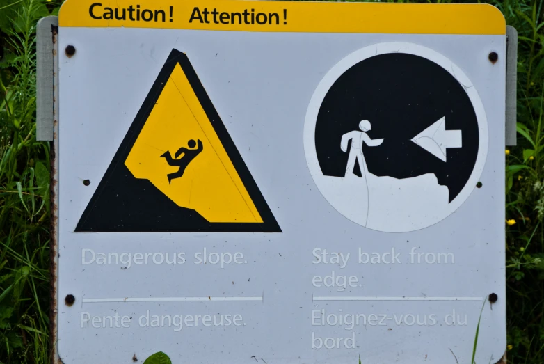 a sign with some warning signs stating that there is a danger zone