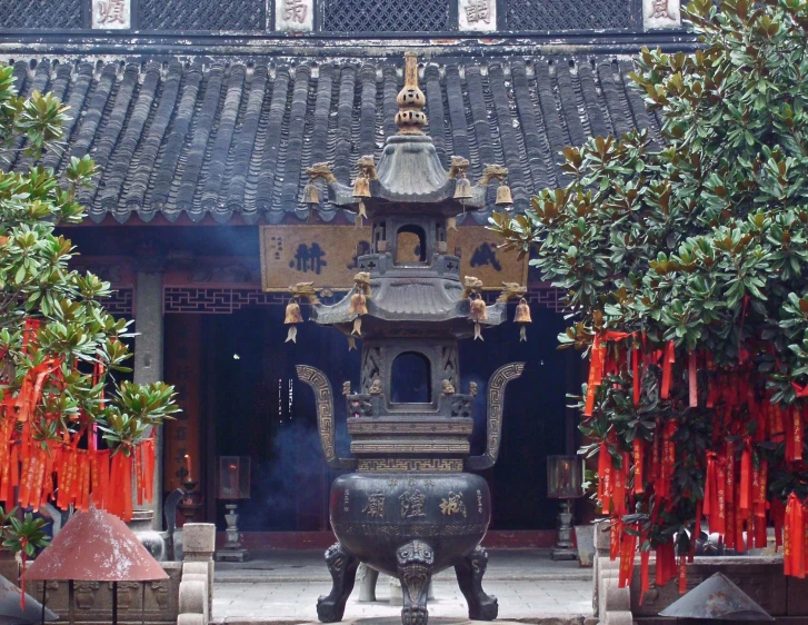 a large sculpture sits in front of many trees